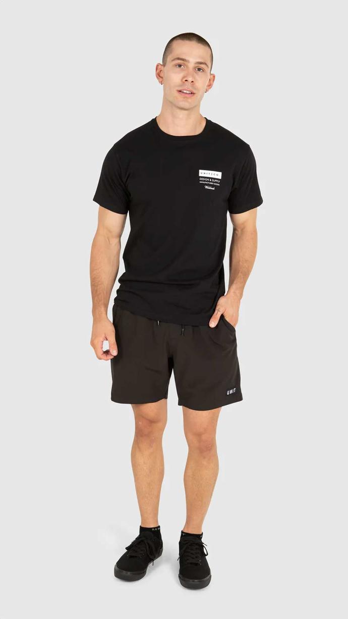 Bald man posing while wear the UNIT Men's Tee Hideout in black